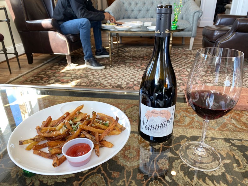 Enjoying the 2018 Maison Sanglier Pommard with truffle fries in the Tower View Tasting Room 