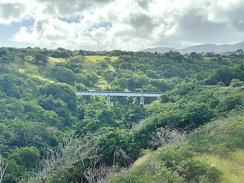 A steel tresses bridge spanning a “ghut” along the coastal railway route