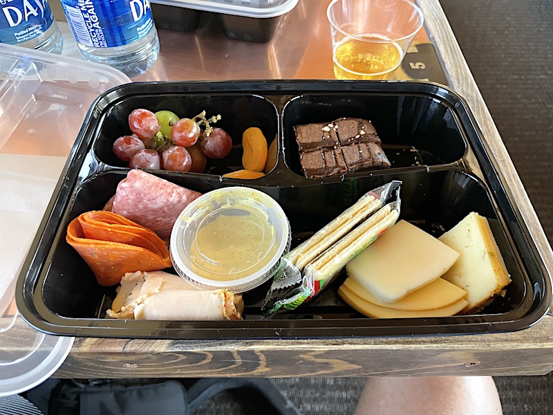 Passenger lunches featuring a sandwich, fruit, and dessert