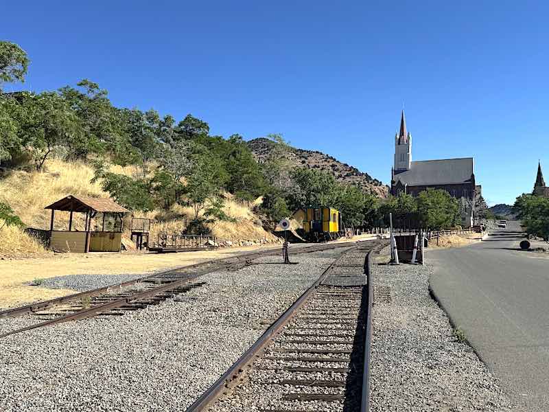 The main railroad depot of the Virginia and Truckee with the famous Mary's in the Mountains Catholic Church in the background