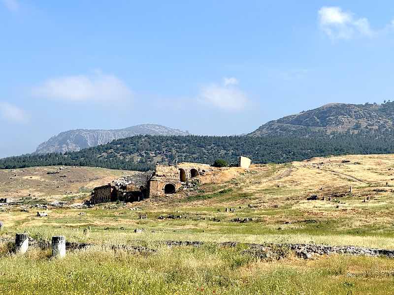 The scattered stones of the city of Hierapolis showing the theater in the background