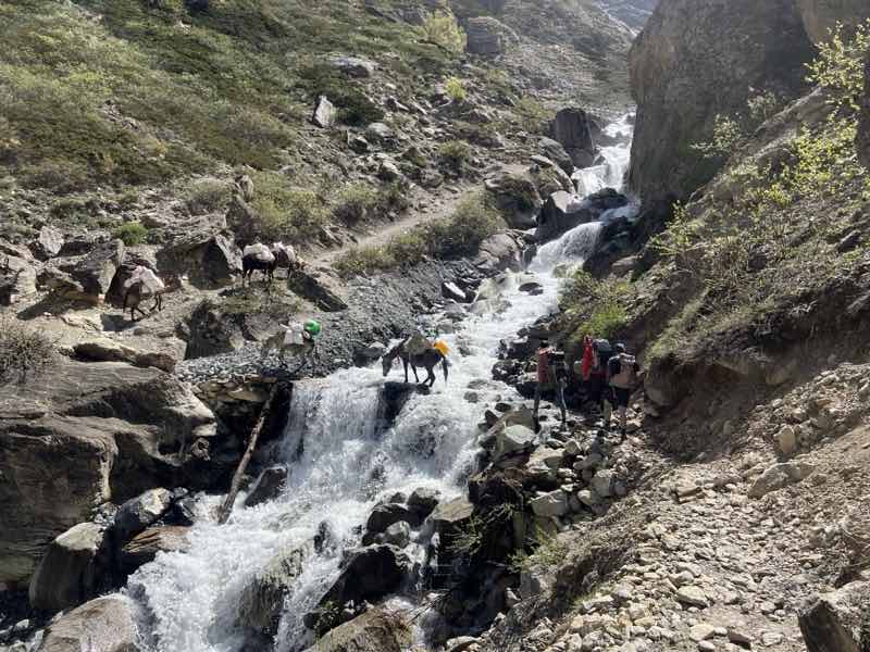 crossing a waterfall in Dolpo trek